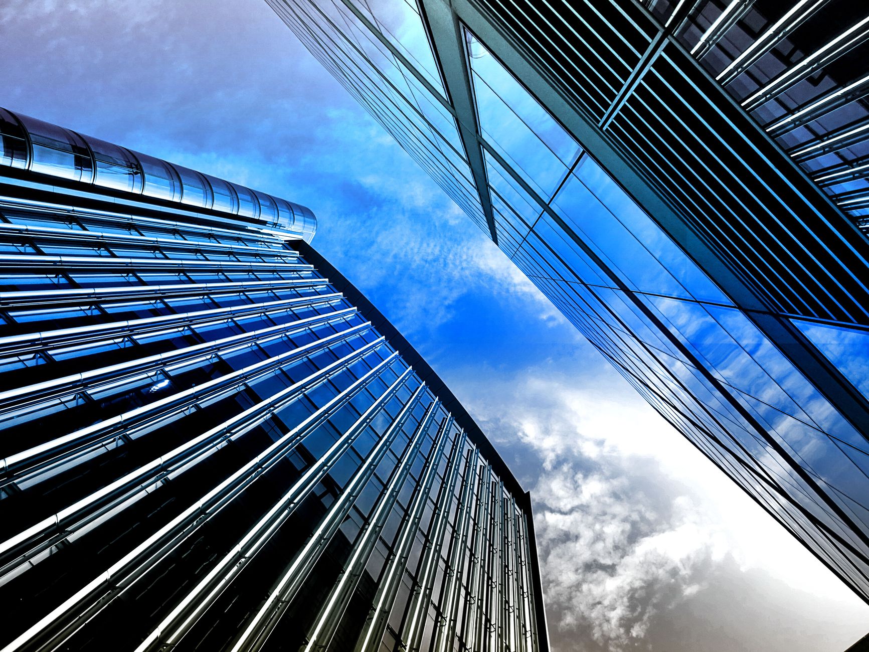 Soaring architectural glass skyscraper tower with modern curved geometric facade.