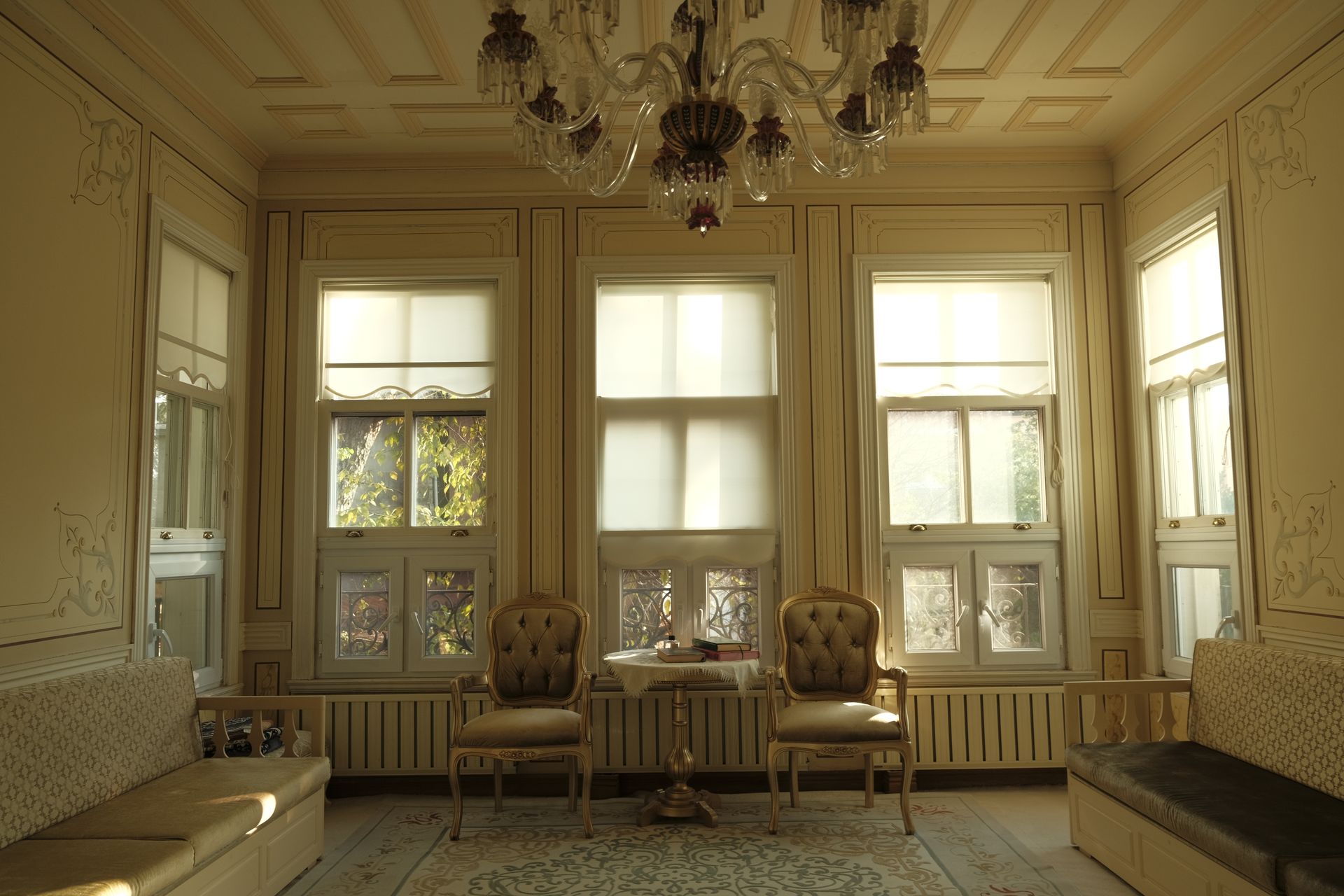 Opulent Ottoman-style luxury room in Istanbul featuring ornate wood carvings, handcrafted oriental furnishings, and lavish interior details.