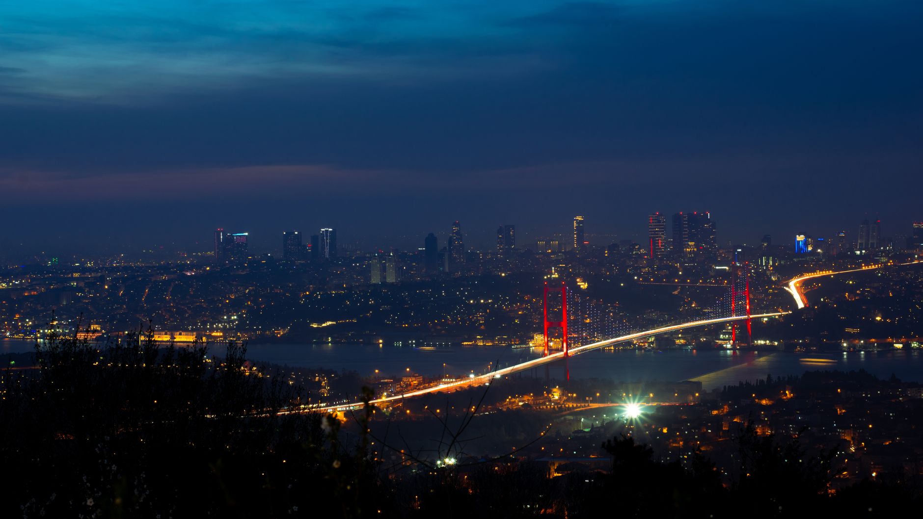 Vehicles traveling across the expansive suspension bridge over the Bosphorus strait.