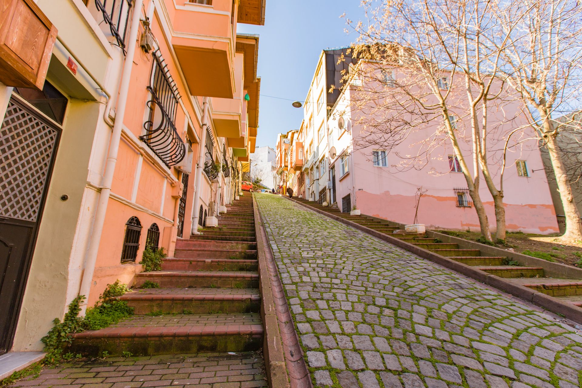 Quiet cobblestone lane lined with pastel historic boutique buildings in the peaceful residential quarters of Sultanahmet.