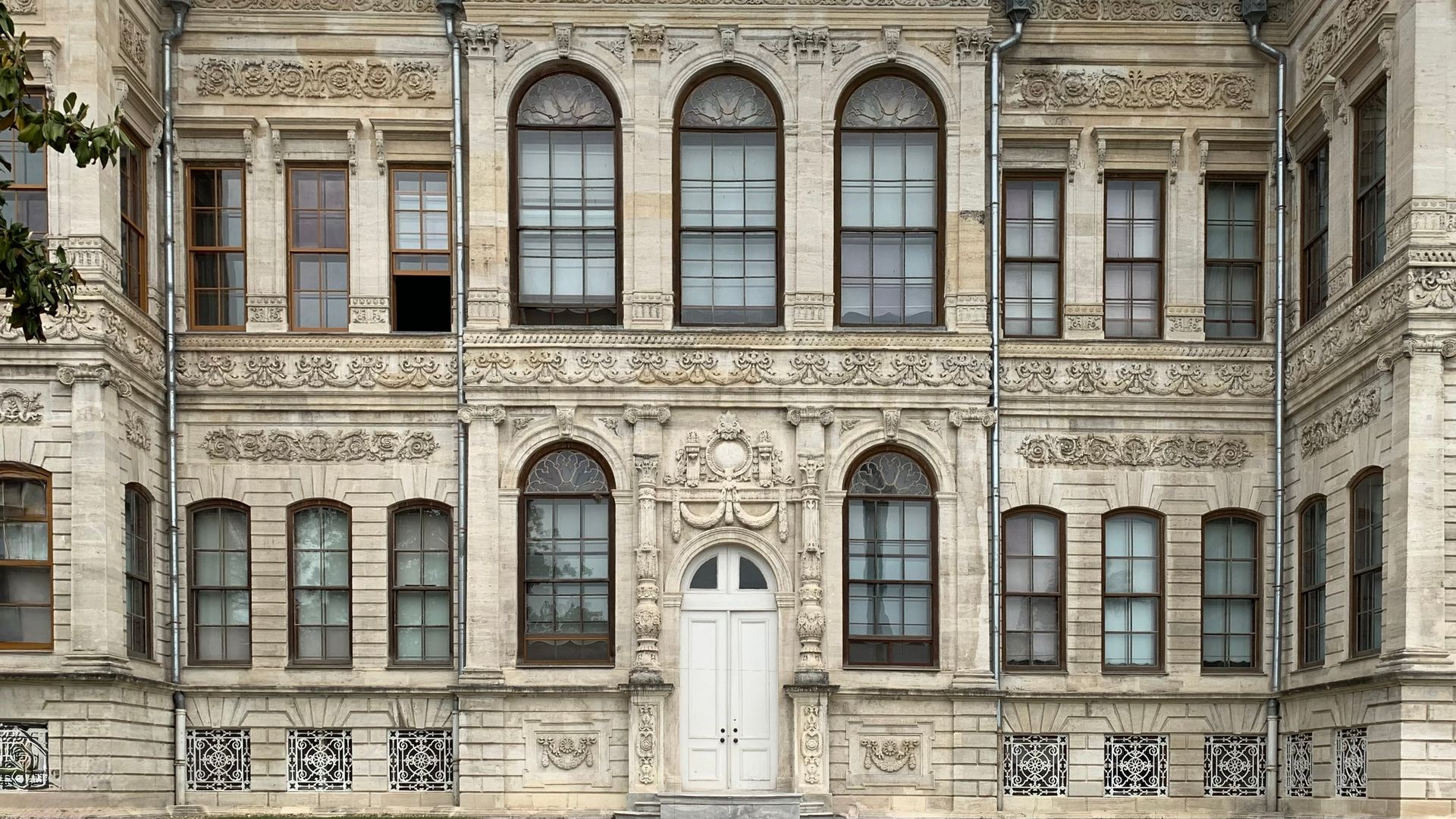Monumental early 20th-century neoclassical facade with rhythmic bay windows and carved stone friezes typical of the historic Tayyare Apartments.