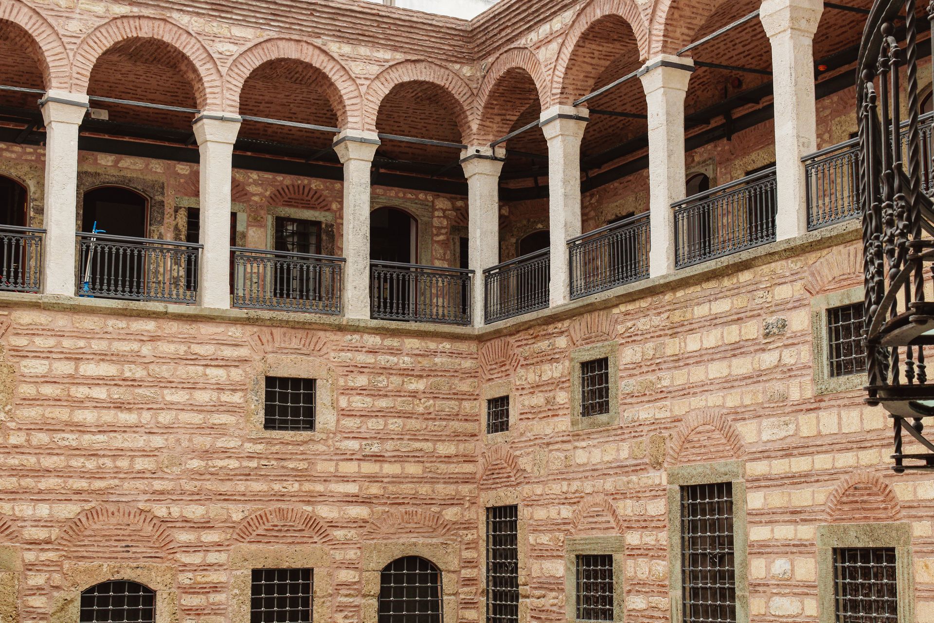 Historic stone courtyard and arched facade of a restored heritage boutique hotel in Istanbul's Sultanahmet district.