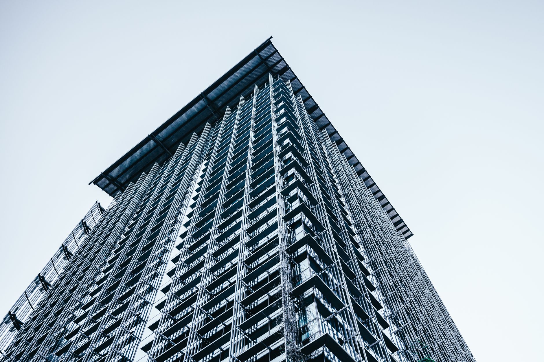Gleaming multi-story glass skyscraper building in the central business district under sunlight.