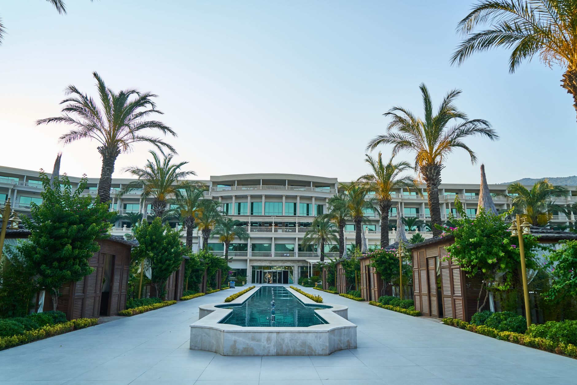 Stylish contemporary boutique hotel exterior with modern geometric facade panels and ground floor reception.