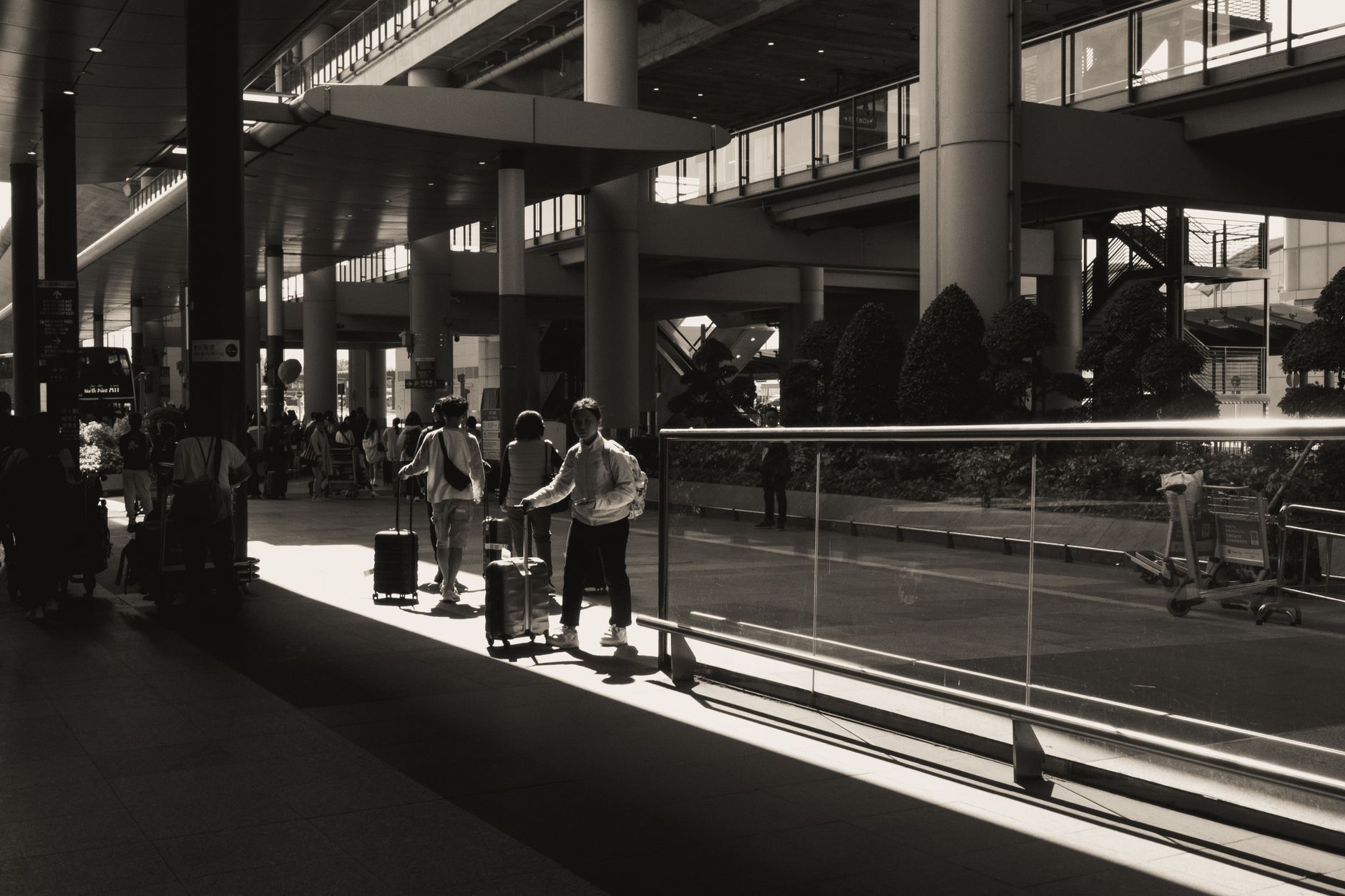 International arrivals concourse with passengers collecting luggage and exiting customs