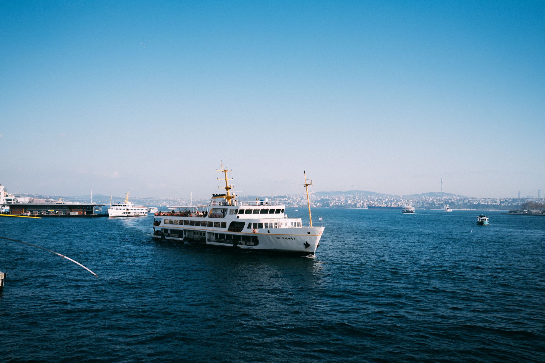 Traditional public passenger ferry departing the Kadıköy terminal quays on the Asian shore.