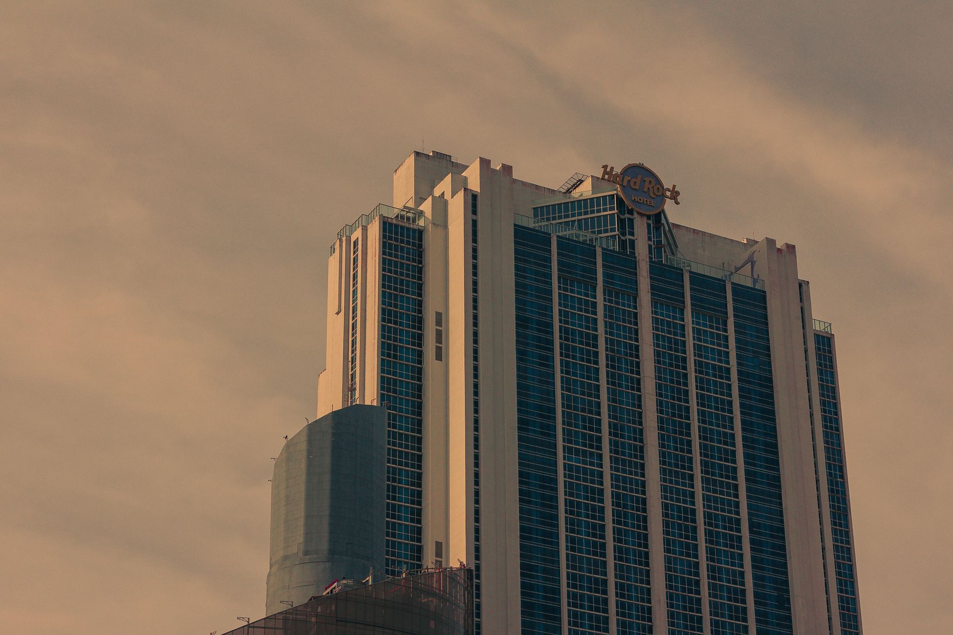 Sleek contemporary high-rise hotel tower situated in a dynamic urban business district.
