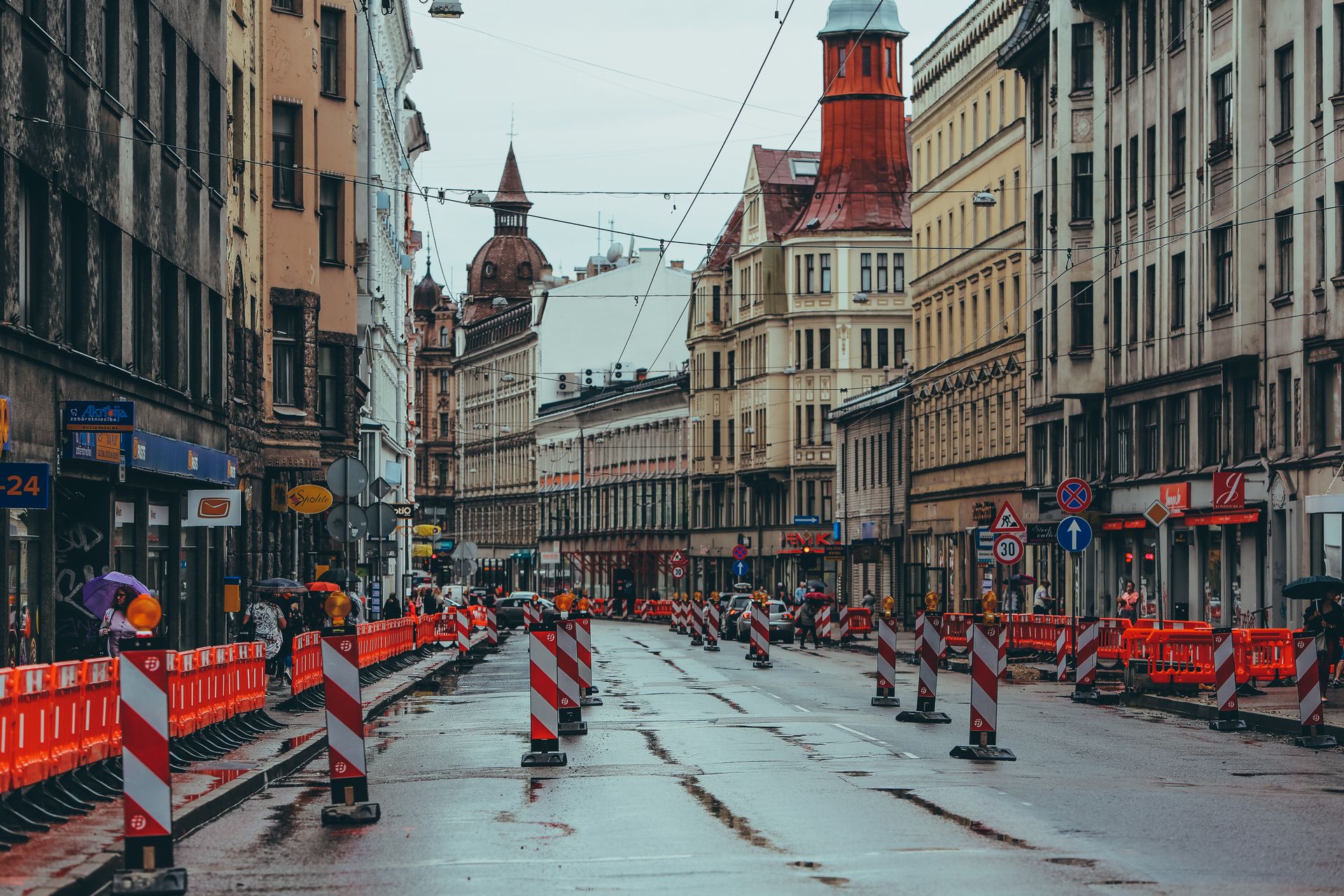 Row of electronic security posts and traffic control bollards restricting vehicular access to a designated historic pedestrian zone.