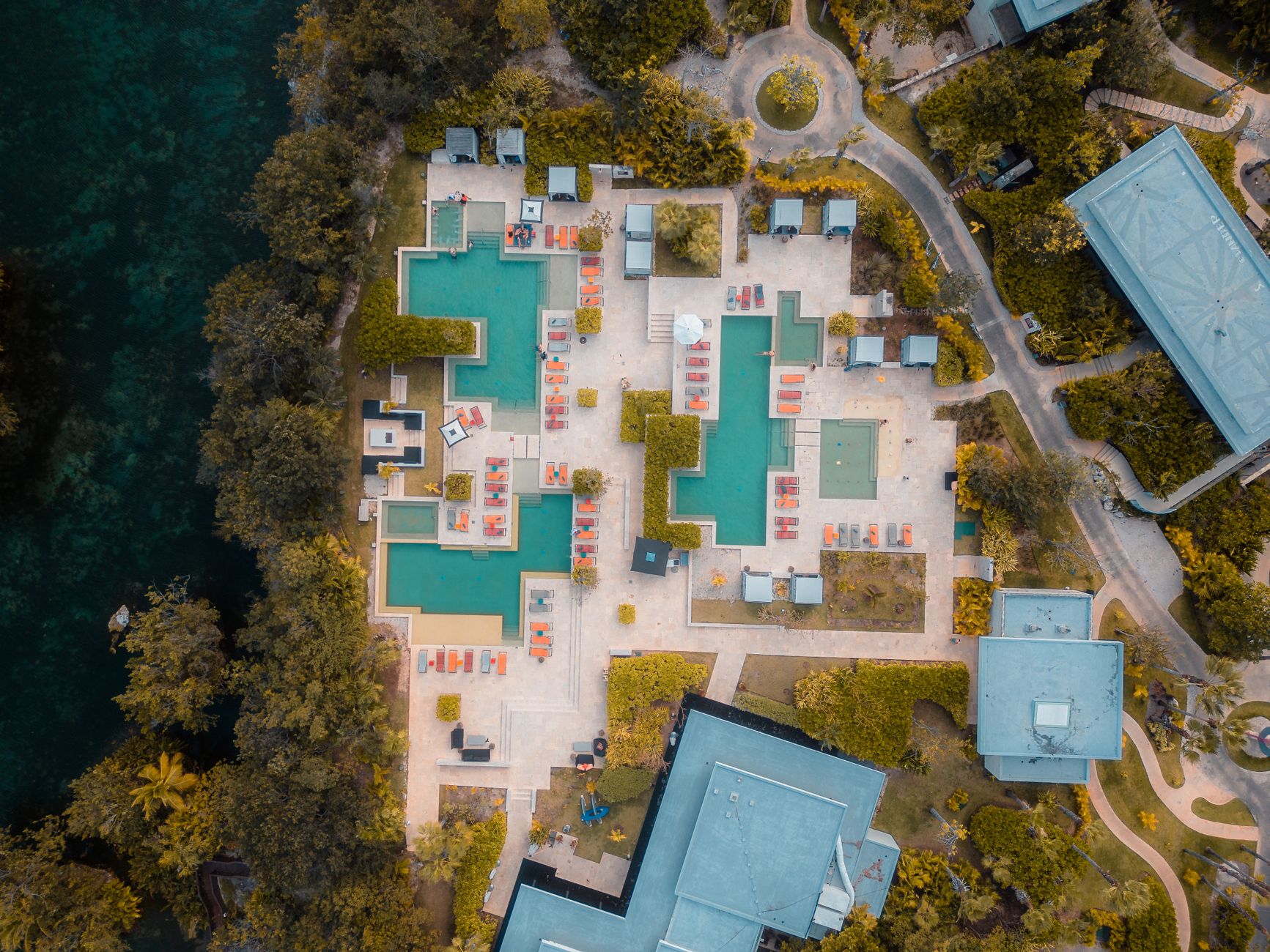 Expansive luxury wellness hotel complex featuring tranquil outdoor pools and landscaped gardens.