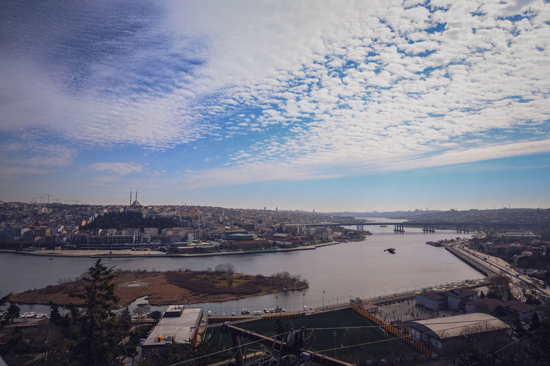 Panoramic rooftop vista overlooking the historic Golden Horn waterway and Istanbul skyline from the Pera district.