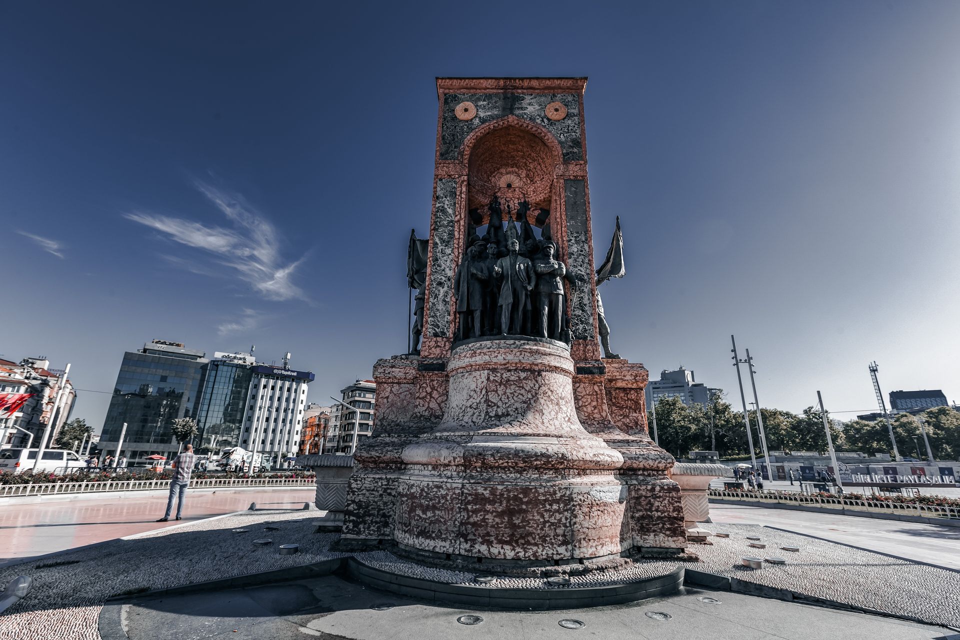 The historic Republic Monument in Taksim Square, Istanbul under a clear blue sky.