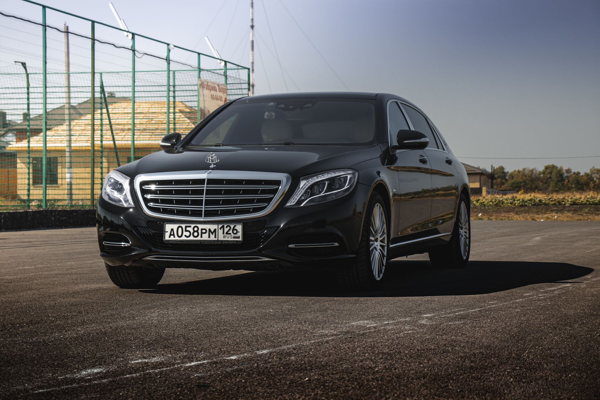 High-end black Mercedes-Maybach luxury executive sedan parked in bright daylight for premium VIP transfers.