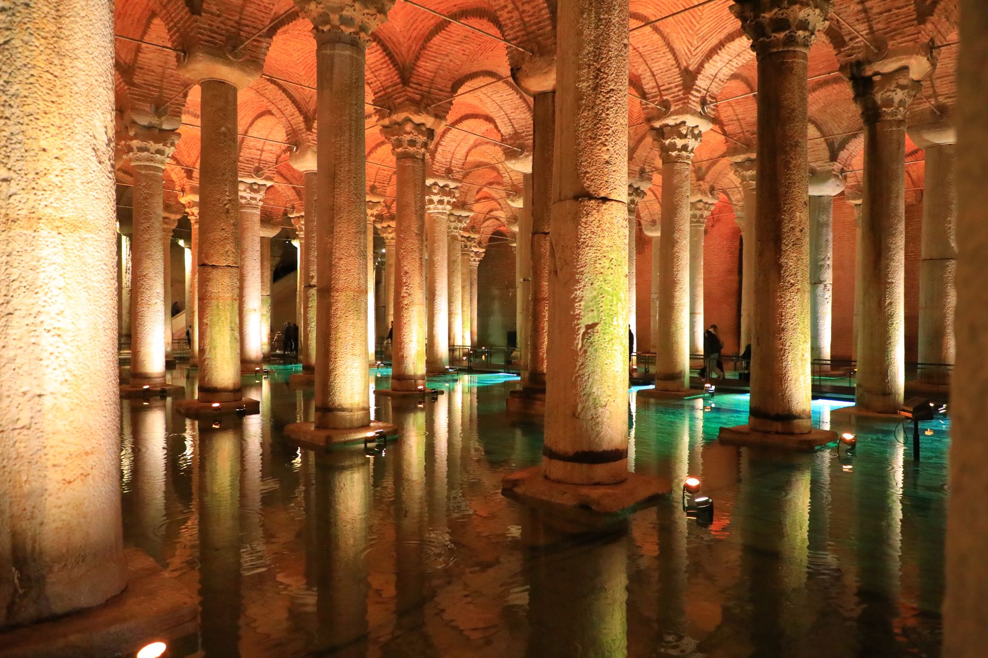 Illuminated marble columns and atmospheric vaulted ceiling of the historic Basilica Cistern on Yerebatan Caddesi in Istanbul.