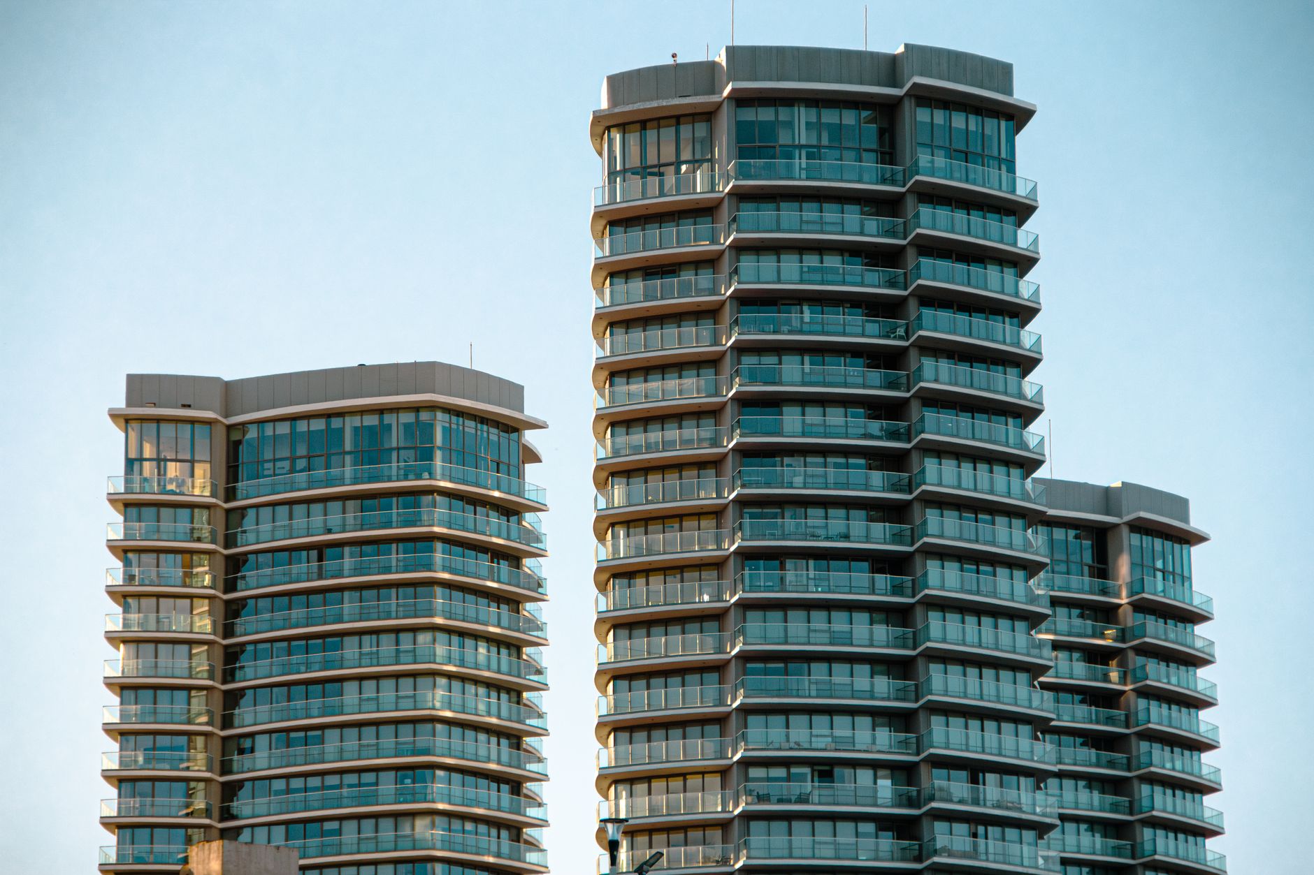 Sleek geometric architectural facade of a luxury high-rise hotel tower.